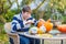 Young man hollowing out a pumpkin to prepare halloween lantern