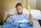 Young man in hospital room after suffering accident eating healthy apple diet clinic food moody and sad