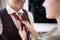 A young man at hotel room dressing up for a business meeting. Hotel  business  people