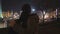 Young man hugging girlfriend with love and care, couple enjoying night city view