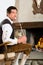 Young man in hunter\'s cabin eating marshmallow