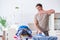 The young man husband doing clothing ironing at home