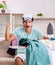 Young man husband ironing at home