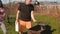 Young man inflates the coals in the grill brazier with a cutting Board.