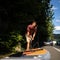 Young man inflating his paddle board with a pump