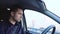 Young man inside car. Driver sitting in front seat and riding alone. Concentrated and serious businessman driving