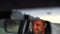 Young man inside car. Happy positive caucasian man driving car fast. Blurred background. Sunrise or sunset outside the