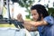 young man instals mountain bike on car roof