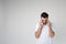 Young man isolated over background. Headache or thinking. Calm peaceful guy in studio stand alone and look down.