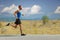 Young man jogging on an open road