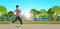 Young man jogging outdoors modern public park guy in headphones running sport activity concept cityscape sunset