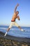 Young man jumping on the blue beach