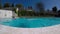 Young man jumping in blue clear pool