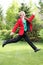 Young man jumping with brightly colored suit