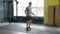 Young man jumping with skipping rope during sports training in gym alone