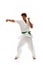 Young man, karate, judo, taekwondo athlete in motion, training, fighting isolated on white studio background
