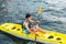 Young man kayaking on a lake