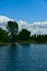 A young man kayaking in a river going to an island full of trees, saint Laurent river, rapides park, Montreal, QC, Canada