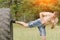 Young man is kicked a foot in a tire. Workout