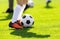 A young man kicking a football outdoors. Young football players