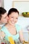 Young man kissing his girlfriend preparing pasta