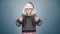 Young man in knitted sweater and santa hat puts on carnival costume details Christmas preparation