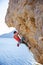 Young man lead climbing on overhanging cliff