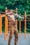 Young man leads healthy lifestyle, engaged in outdoor sports using SANDBAG