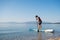 Young man learning how to paddle on a sup board