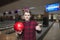 Young man likes playing bowling. Young handsome man standing with a bowling ball in his hands and showing his thumb up.