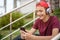 Young man listen to the music in a big earphones, in the street.  Happy teenage boy with mobile phone and headphones, outdoors.