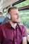 Young Man Listening To Music On Headphones During Journey To Work