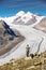 Young man looking at majestic view to Aletsch glacier, the large