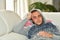 A young man looking sick lying on a sofa and covered with a blanket. Sickness and healthcare concept