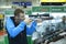 Young man looking through the telescopic sight of a rifle, gun shop