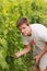 Young man looks in grapes