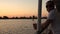 A young man looks at the river from the deck of a motor ship