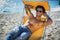 Young man lying on deckchair at beach