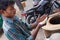 Young man making chapati at streetside restaurant in Delhi, India