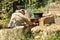 Young man making fire for cooking outside