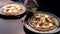 Young man making homemade vegetarian pizza at home adding tomato sauce to the base