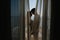 Young man making love confession to his charming girlfriend standing on balcony behind the curtains in morning. Portrait