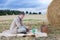 Young man making picnic on hay field