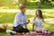 Young man making proposal to his girlfriend, giving her engagement ring at park