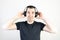 young man male guy model wearing headphones cool fashion style looks unhappy angry stand wear bad music sound listening