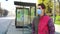 Young man in medical mask waiting for bus on empty bus stop