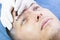 Young man microblading procedure to improve the condition of a mans eyebrows