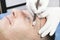 Young man microblading procedure to improve the condition of a mans eyebrows