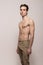 Young man model shirtless body posing pants