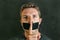 Young man with mouth and lips sealed covered with adhesive tape in censorship coerced freedom of speech and forced silence and sec